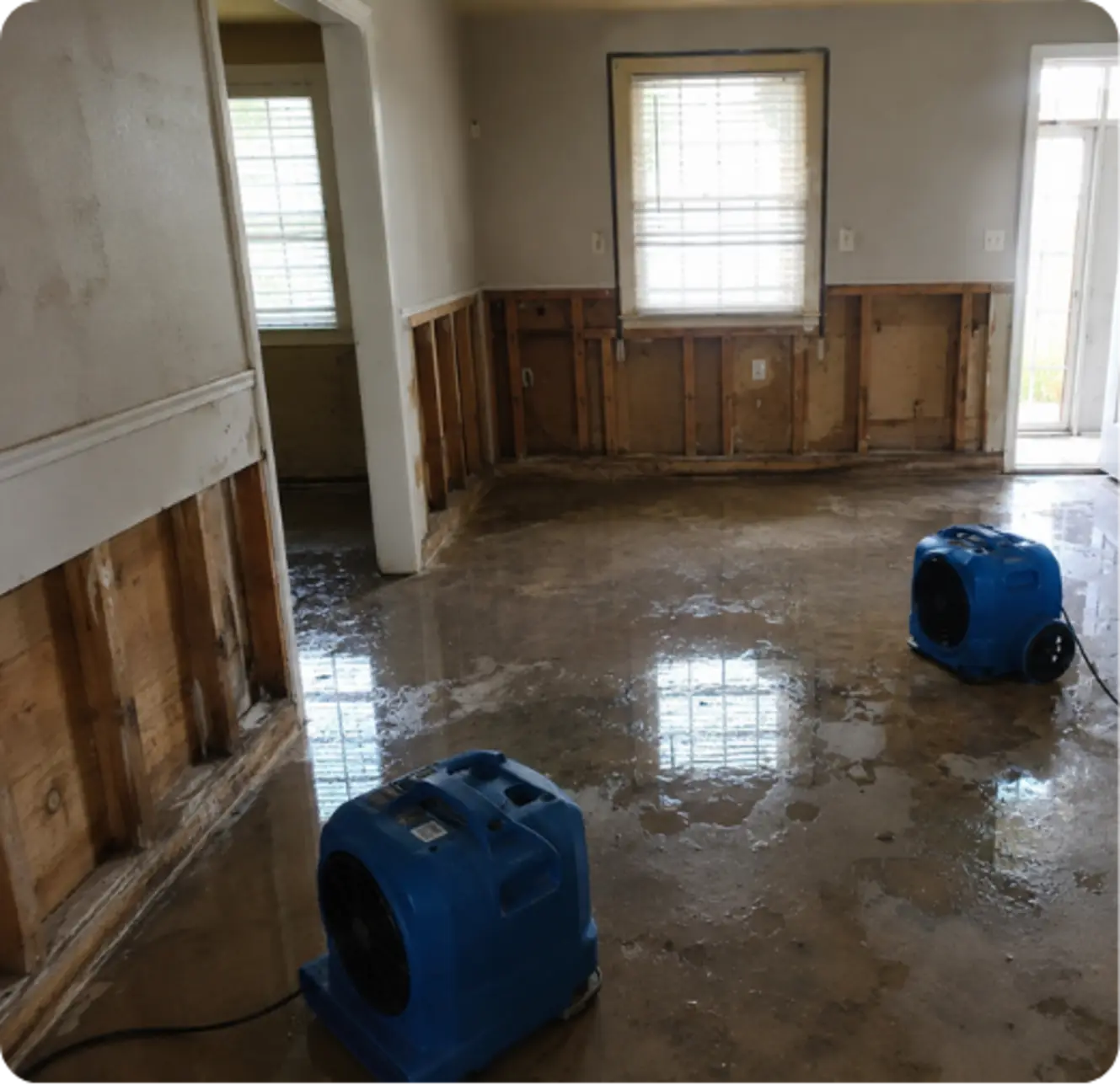 Industrial drying fans in a water-damaged room